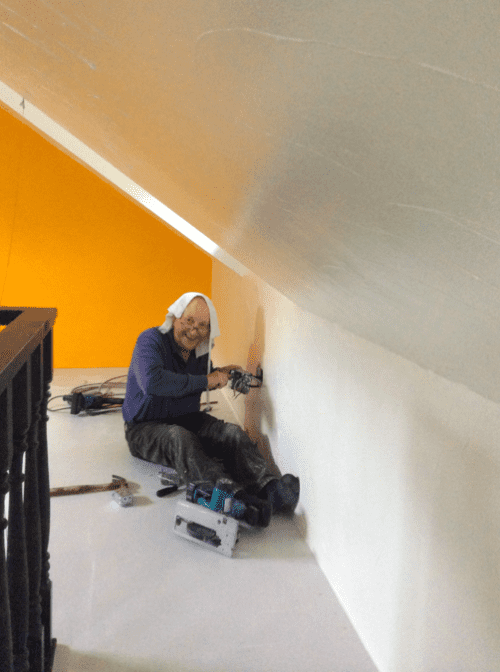 Dad putting in new electrical outlets upstairs in the newly christened “office”. He has a towel on his head to soak up the sweat from his hormone-therapy induced hot flashes. 