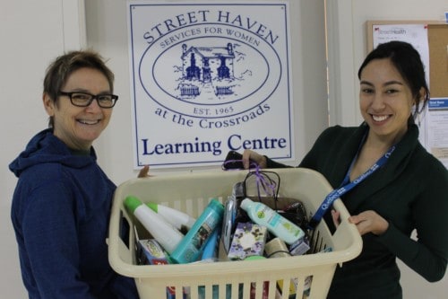 Photo: Mary Choy (right) accepts a donation of toiletries to the Street Haven Learning Centre. (via Facebook)
