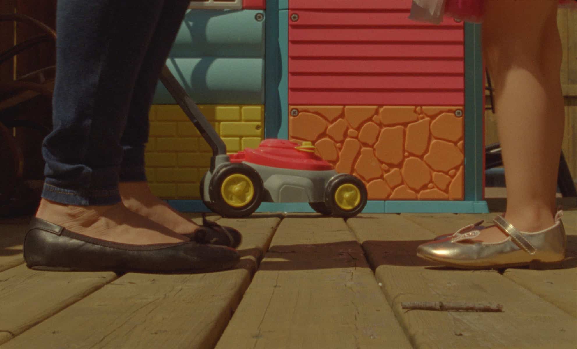 A woman's feet across from her child's feet.