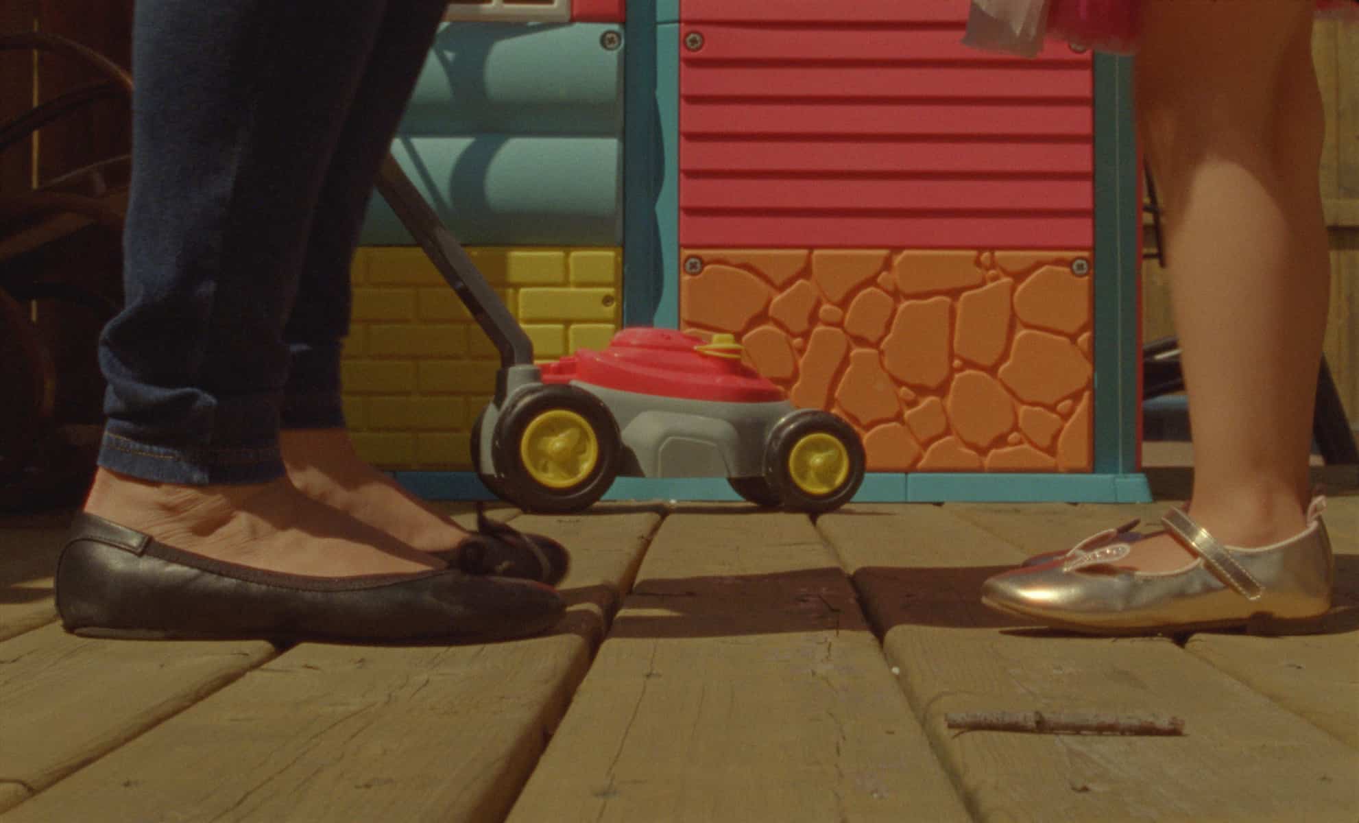 A woman's feet across from her child's feet.